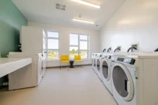 Laundry facility at Lightfighter Village with washers, dryers, and seating
