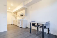 Kitchen and dining area inside a Lightfighter Village apartment unit