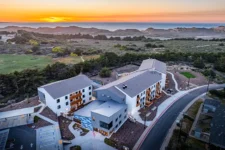 Aerial sunset view of Lightfighter Village with the Pacific coastline in the background