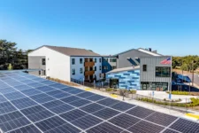 Solar carports at Lightfighter Village with the residential building in the background